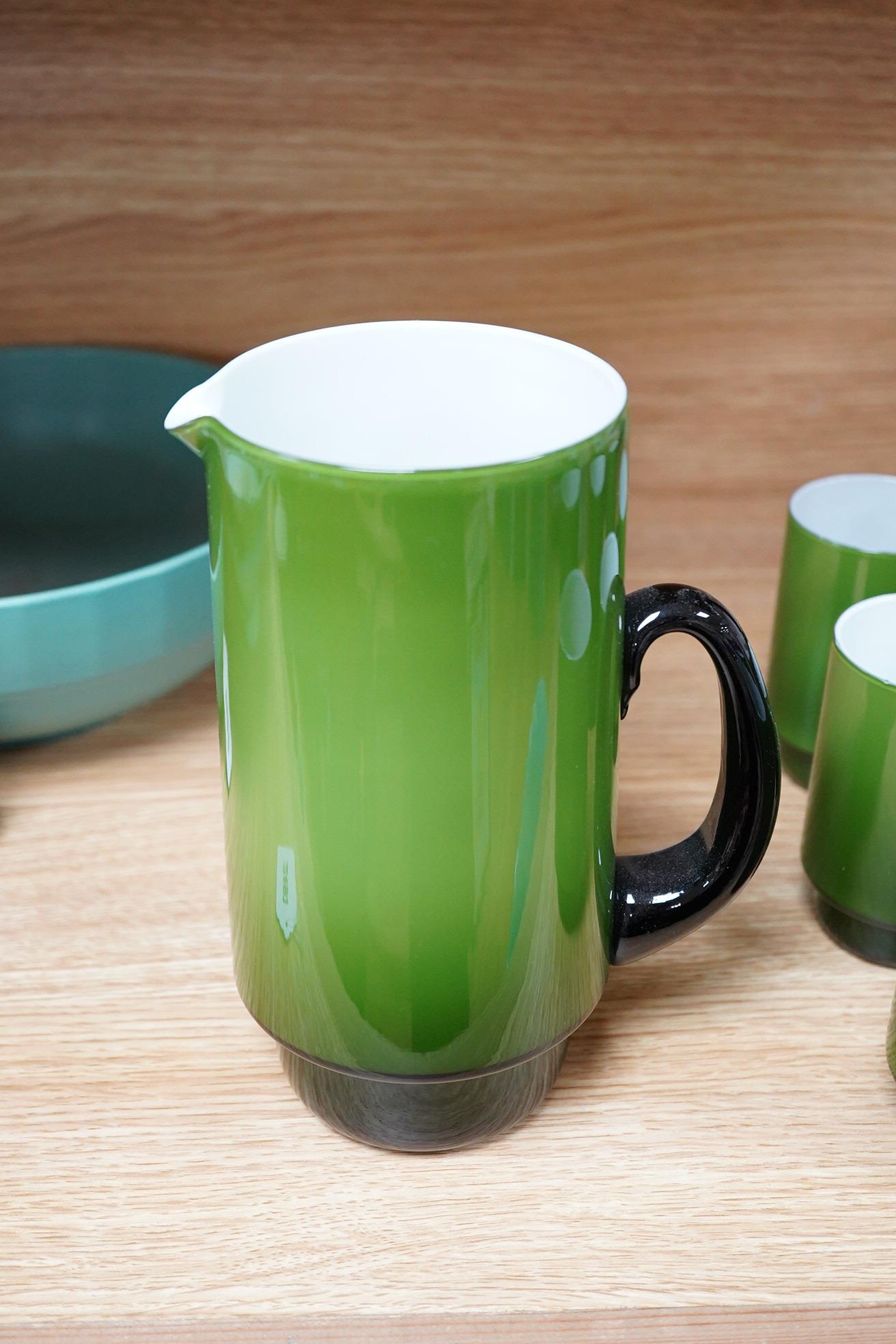 Michael Bang for Holmegaard glass, a green cased jug and six mugs with stepped bases, largest 20cm high
